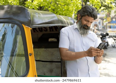 Indian auto driver using mobile phone - Powered by Shutterstock