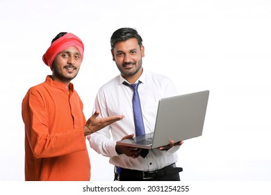 Indian Bank Officer Or Corporate Government Employee Showing Some Information To Farmer In Laptop.