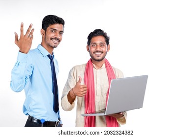 Indian Bank Officer Or Corporate Government Employee Showing Some Information To Farmer In Laptop.
