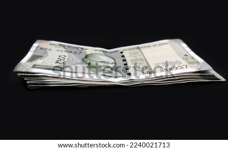Indian banknotes isolated on black background.