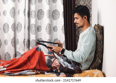 Indian Bearded Young Man Opening Laptop For Start Office Work Or Video Call Getting Ready For Work In The Morning At The Bed Near Window In A Beautiful House Starting Of A Work Day