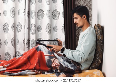 Indian Bearded Young Man Opening Laptop For Start Office Work Or Video Call Getting Ready For Work In The Morning At The Bed Near Window In A Beautiful House Starting Of A Work Day