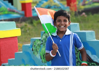 Indian Boy Child Holding Indian Flag On The Occasion Of Indian Independence Day Celebration. Smiling Toddler Holds A Flag Of India.