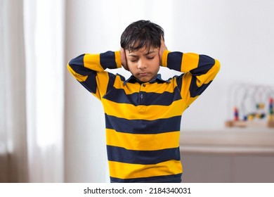 An Indian Boy Closed Eyes Covering Ears With Hands