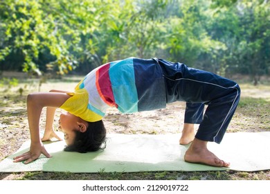 An Indian Boy Doing Yoga Camel Pose