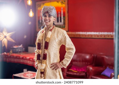 Indian boy dressed in Bollywood clothes and turban with hands on hips looking at camera and smiling - Powered by Shutterstock