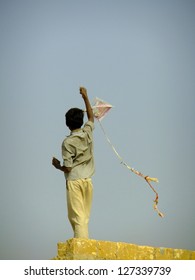 Indian Boy Flying A Kite