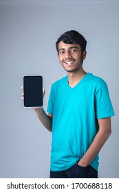 Indian boy holding digital tablet