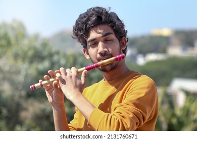 Indian Boy Playing Bansuri Indian Bamboo Flute.