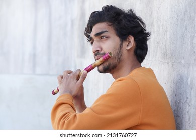 Indian Boy Playing Bansuri Indian Bamboo Flute.