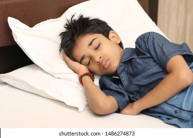 Indian Boy Sleeping In Bed At Home