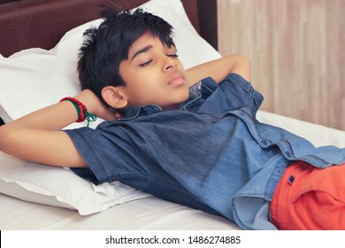 Indian Boy Sleeping In Bed At Home