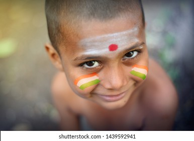 indian boy tricolour face painted with indian flag colours.Suitable for Happy Independence day or Republic day greeting