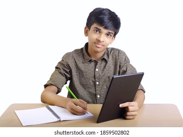 Indian Boy Using Digital Tablet While Attending The Online Classes At Home	