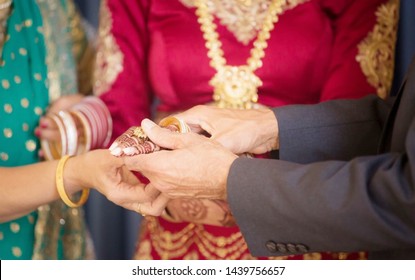 Indian Bride Getting Help With Her Bangles