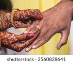 Indian bride and groom ceremony with gold ring on finger