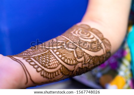 Indian bride hands decorated with Mehendi or Henna for wedding ceremony
