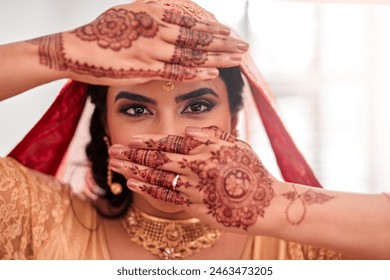 Indian bride, portrait and henna for marriage, celebration and love for wedding. Woman, accessories or culture for traditional mehendi hands, sari or hindu bridal jewelry for commitment and happiness - Powered by Shutterstock