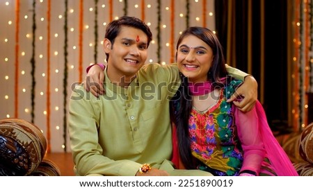 Indian brother and sister sharing love on the occasion of Raksha Bandhan - Festival concept, Indian Model. Good looking siblings smiling and showing their brother-sister relationship by hugging 