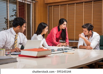 Indian Business / Corporate Culture And People Working In The Office Concept With Laptop, Papers, Meetings And Discussions