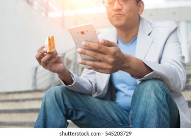 Indian Business Male Eating Bread