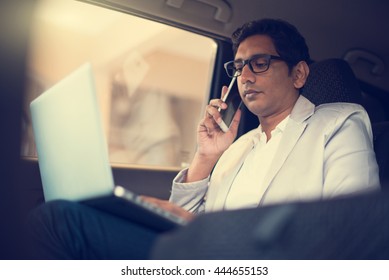 Indian Business Male Using Laptop And Phone Inside The Car