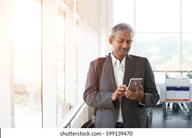 Indian Business Male Using Phone At The Airport