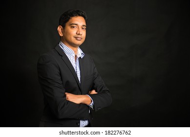 Indian Business Man On Dark Background, Crossed Arm 