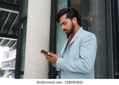 Indian Business Man Walking Outside To Station Or Airport Talking On The Phone 