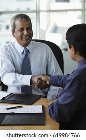 Indian Business Men Shaking Hands And Smiling