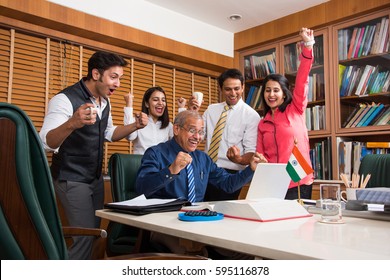 Indian Business People / Corporate culture and Working in the office and Teamwork Concept with Laptop, papers, meetings, Cel phones, presentations and discussions - Powered by Shutterstock