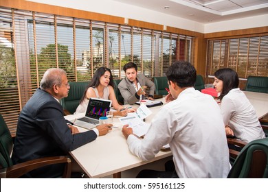 Indian Business People / Corporate culture and Working in the office Concept with Laptop, papers, meetings, presentations and discussions