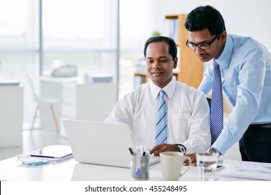 Indian Business People Working On Laptop Together