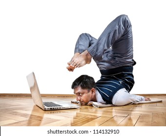 Indian Businessman Doing Yoga And Looking At Laptop In The Office At White Background. Free Space For Your Text