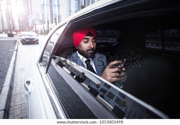 Indian businessman\
his  company car in\
India