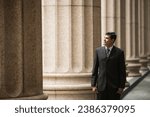 Indian businessman. Professional Lawyer or business man outside a colonial courthouse building. 
