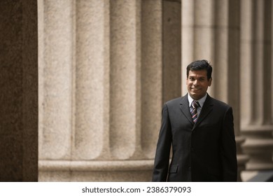 Indian businessman. Professional Lawyer or business man outside a colonial courthouse building.  - Shutterstock ID 2386379093