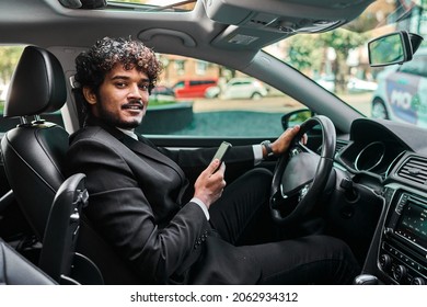 Indian Businessman In A Suit Driving His Car.