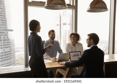 Indian businesswoman mentor leading corporate meeting in modern office with panoramic windows, boardroom, smiling colleagues sharing ideas, business partners discussing project strategy, negotiating