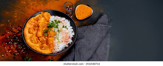 Indian Butter Chicken Curry With Basmati Rice On Dark Background. Traditional Homemade Food Concept. Top View, Copy Space