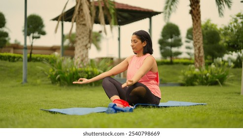 Indian calm peaceful senior old woman sitting on yoga mat closed eyes do meditation outdoor modern garden. Mature older female meditating take deep breath of fresh air practise asana relieve stress - Powered by Shutterstock