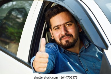 Indian car drive showing thumps up form car's open window