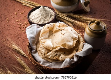 Indian Chapati / Fulka or Gehu Roti with wheat grains in background. It's a Healthy fiber rich traditional North/South Indian food, selective focus
