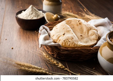 Indian Chapati / Fulka or Gehu Roti with wheat grains in background. It's a Healthy fiber rich traditional North/South Indian food, selective focus
