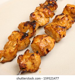 Indian chicken tikka kebabs on metal skewers