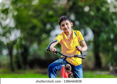 Indian child on bicycle, playing in outdoor