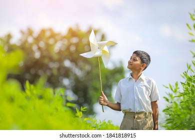 Indian Child Running And Playing With Pinwheel