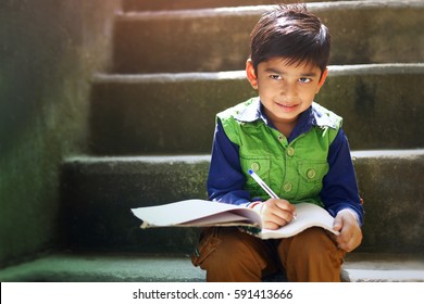 Indian Child Writing On Note Book