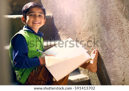 Indian child writing on note book
