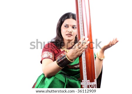 An Indian classical music singer in performance with the instrument called Tanpura.